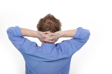 Man with his hands clasped behind his neck