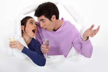 Man and woman having fun with glass of champagne in hand
