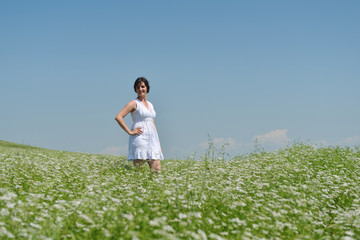 Fototapeta na wymiar Young happy woman in green field