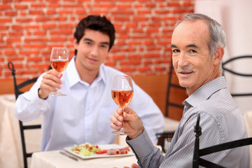 Father and son having lunch