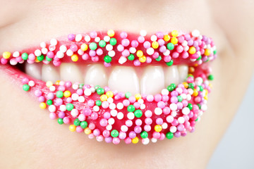 Womans lips with colored candy