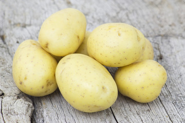 potatoes on old wooden background