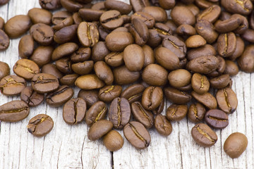 Coffee beans on old wooden background
