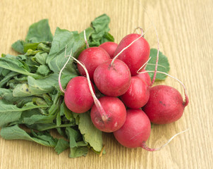 Bunch of radish on brown desk closeup