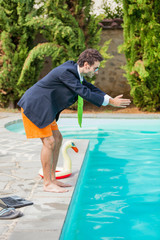 Funny Young Businessman with SwimmingTrunks Diving  into the Poo