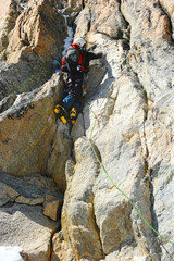 Obraz premium Climber reaching the summit of mountain