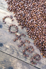 The word coffee beans laid out the wood table.