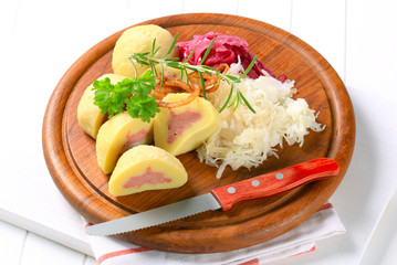 Meat stuffed potato dumplings with shredded cabbage