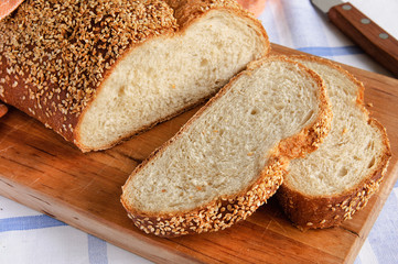 Sliced white bread on a wooden cutting board