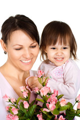 Fototapeta na wymiar Beautiful woman with a daughter and flowers