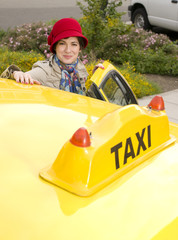 Woman enters a Taxi