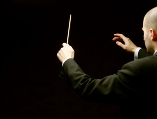A concert conductor with a baton
