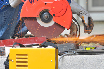 worker cutting metal