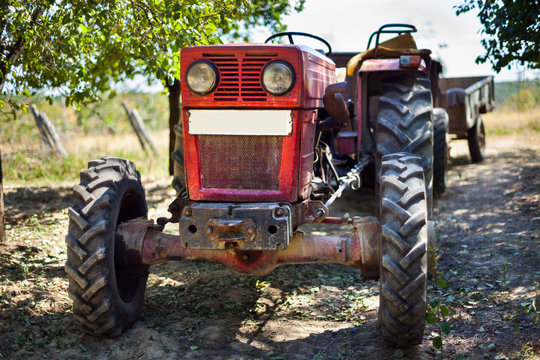 Tractor with trailer in an orchard