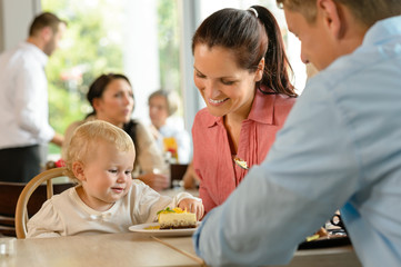 Mother and father with child eating cake