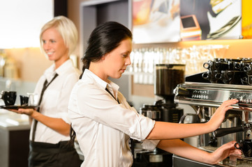 Staff at cafe making coffee espresso machine