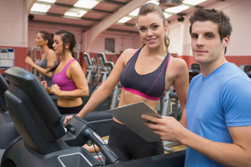 Fototapeta premium Gym Instructor and woman in the gym