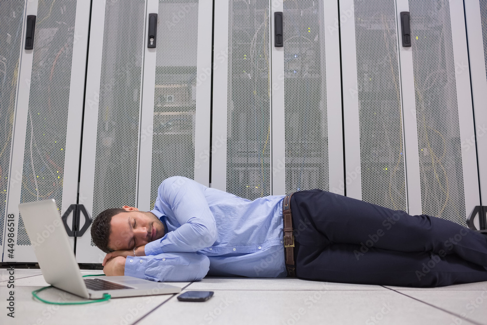 Poster man sleeping while doing maintenance on servers