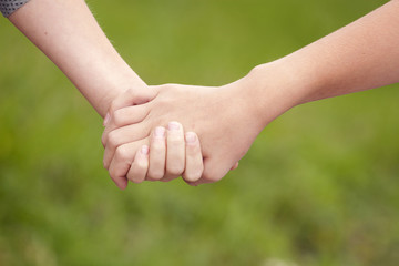 two children's hands keeping together