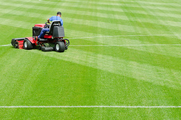 Mowing grass in a football stadium