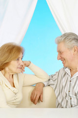 Married elderly couple resting at home