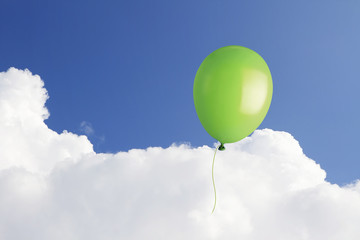 Green balloon in the sky with copy space