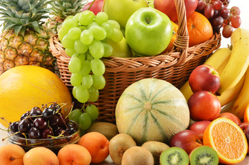Composition with assorted fruits in wicker basket