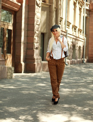 Young old fashioned girl walking on the vintage street