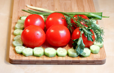 Fresh vegetables and greens on the chopping board