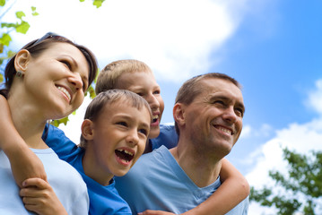 family plays at nature