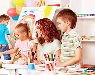Child painting at easel.