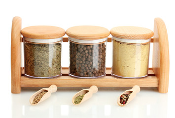 jars and wooden spoons with spices