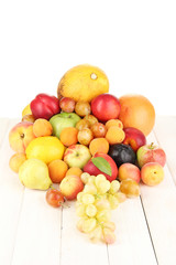 Still life of fruit on wooden table isolated on white