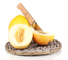 Ripe melons on wicker cradle isolated on white