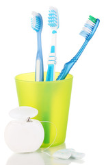 Toothbrushes, chewing gum and dental floss isolated on white