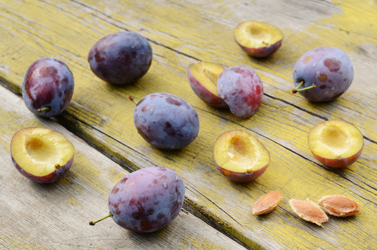 Plums on shabby wooden table