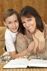 Caucasian boy with his mother sitting