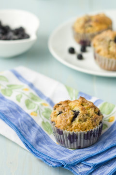 Blueberry muffin on napkin withfresh berries
