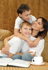 Beautiful charming mummy and sons sitting