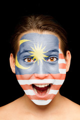 girl with malaysian flag painted on her face