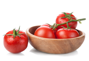 brush tomatoes in a wooden bowl isolated on white background