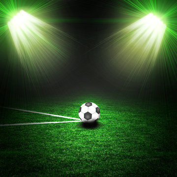 Soccer ball on the green field with lightnings