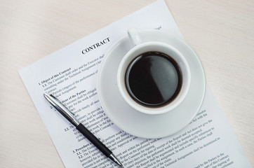 White cup on cotract and wooden table