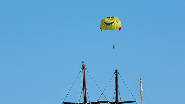 Colorful paraplane with a picture of a smile on it