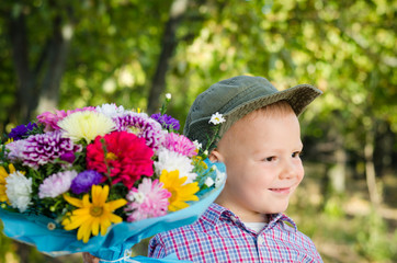 Little boy with flowers for a loved one