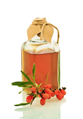 glass bottle of olive oil with a branch isolated on white backgr