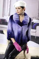 High fashion model in winter fur coat clothes posing