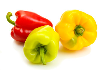 fresh yellow, red and green bell peppers isolated on white