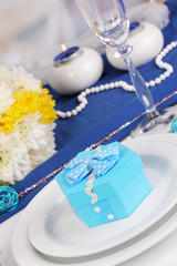 Blue gift for guests on wedding table close-up