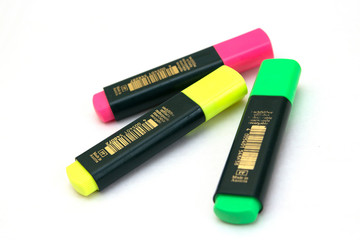 Three colored markers on white background